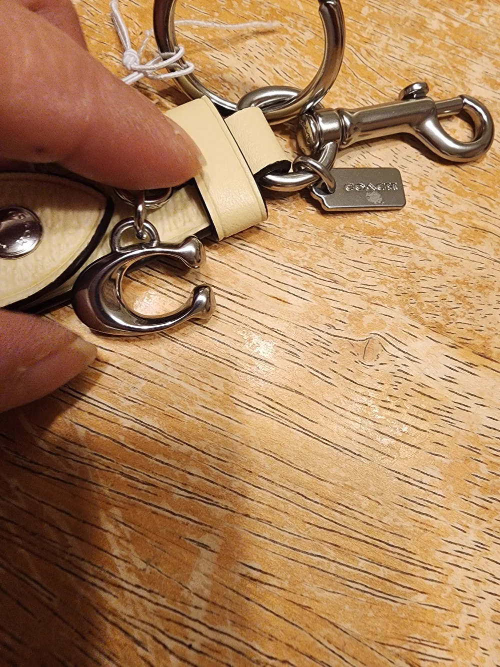 Coach Trigger Snap Bag Charm in Signature Canvas featuring a sleek Beige/silver